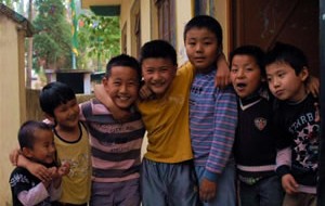 A group of children outside the community hall at Dekyi Ling built with funds provided by STCS