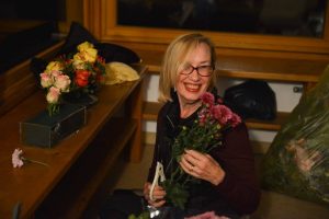 Lopön Barabara Ryan arranging the flowers for the shrine.